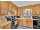 Functional kitchen with wooden cabinets, black appliances, and a double basin sink at 20 Juniper Se Ln, Cartersville, GA 30121