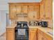 Kitchen with wooden cabinets, black appliances, and practical countertop space at 20 Juniper Se Ln, Cartersville, GA 30121