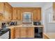 Functional kitchen with wooden cabinets, black appliances, and a double basin sink at 20 Juniper Se Ln, Cartersville, GA 30121