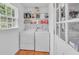 A laundry room with a washer, dryer, window and storage shelves at 20 Juniper Se Ln, Cartersville, GA 30121