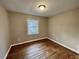 This bedroom features hardwood floors and a window providing natural light at 371 Landers Sw Dr, Mableton, GA 30126