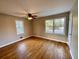 A bright bedroom features hardwood floors, neutral paint, and a ceiling fan at 371 Landers Sw Dr, Mableton, GA 30126