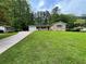 Charming single-story home with a well-manicured lawn, lovely landscaping and a long driveway at 371 Landers Sw Dr, Mableton, GA 30126