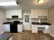 Functional kitchen with white cabinets, dark countertops, and stainless-steel appliances at 371 Landers Sw Dr, Mableton, GA 30126