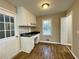 Spacious kitchen showcasing white cabinets, black countertops, and desk area with backyard views at 371 Landers Sw Dr, Mableton, GA 30126