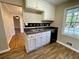 Kitchen with a sink, black and white backsplash, and view of hardwood floors in adjacent room at 371 Landers Sw Dr, Mableton, GA 30126