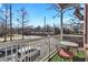 Cozy balcony with white railings and a table set, overlooking a tree-lined street at 1258 Dekalb Ne Ave # 129, Atlanta, GA 30307