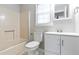 Modern bathroom featuring a vanity, toilet, shower with tub, and window at 37 Indian Hills Ct, Dallas, GA 30157
