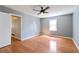 An empty bedroom with hardwood floors, a window, a ceiling fan with a light fixture at 37 Indian Hills Ct, Dallas, GA 30157