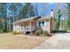 View of the exterior of the house highlighting the yard and driveway at 37 Indian Hills Ct, Dallas, GA 30157