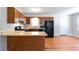 Traditional kitchen features wooden cabinets, light countertops, and black appliances at 37 Indian Hills Ct, Dallas, GA 30157