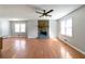 Bright living room featuring hardwood floors and a stone fireplace at 37 Indian Hills Ct, Dallas, GA 30157