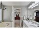 Bathroom featuring a double vanity and an open doorway to the main bedroom at 4184 Wyndham Park Way, Buford, GA 30519