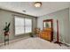 Bright bedroom with neutral carpet, large window with blinds, and classic wooden furniture at 4184 Wyndham Park Way, Buford, GA 30519