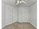 Bedroom with a ceiling fan, carpeting and two closets at 4184 Wyndham Park Way, Buford, GA 30519