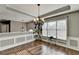 This dining room has decorative molding, dark wood floors, and a modern chandelier at 4184 Wyndham Park Way, Buford, GA 30519