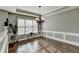 Elegant dining room featuring hardwood floors, stylish lighting, and large windows at 4184 Wyndham Park Way, Buford, GA 30519