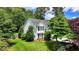 Charming two-story home features a well-manicured lawn and mature trees providing shade at 4184 Wyndham Park Way, Buford, GA 30519