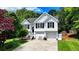Charming two-story home with white siding, black shutters, and a well-manicured front yard at 4184 Wyndham Park Way, Buford, GA 30519