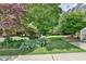 Beautifully landscaped front yard with lush greenery and well-maintained lawn leading to the home at 4184 Wyndham Park Way, Buford, GA 30519