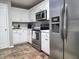 This kitchen has stainless steel appliances, white cabinets, and tile floors at 4184 Wyndham Park Way, Buford, GA 30519