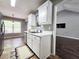 This kitchen has stainless steel appliances, white cabinets, tile floors, and a view to the backyard at 4184 Wyndham Park Way, Buford, GA 30519