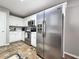 This kitchen has stainless steel appliances, white cabinets, and tile floors at 4184 Wyndham Park Way, Buford, GA 30519