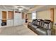 Basement recreation room features built-in shelves, and comfortable leather seating at 4184 Wyndham Park Way, Buford, GA 30519