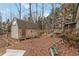 Backyard showing wooded area with outbuilding/shed providing extra storage space on a lush lot at 1220 Tab Roberts Rd, Lawrenceville, GA 30043