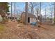 View of backyard with storage shed in a wooded area providing a blend of functionality and outdoor charm at 1220 Tab Roberts Rd, Lawrenceville, GA 30043