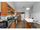 Functional kitchen featuring wood cabinets, gas range, and spacious island for food preparation and casual dining at 1220 Tab Roberts Rd, Lawrenceville, GA 30043