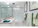 Bathroom with a glass-enclosed shower, granite countertop, and patterned wallpaper at 145 15Th Ne St # 843, Atlanta, GA 30309