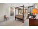 This bedroom features a four-poster bed, neutral decor, and plenty of natural light from the large windows at 145 15Th Ne St # 843, Atlanta, GA 30309