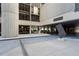 Modern building entrance with concrete columns, planters, and drive-through underpass for convenient access at 145 15Th Ne St # 843, Atlanta, GA 30309