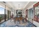 Bright dining area featuring a glass table, chandelier, and balcony access for sophisticated meals with a view at 145 15Th Ne St # 843, Atlanta, GA 30309