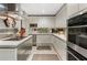 Modern kitchen with stainless steel appliances, white cabinetry and mirrored backsplash at 145 15Th Ne St # 843, Atlanta, GA 30309