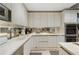 Bright kitchen with modern cabinets, a stainless steel microwave, mirrored backsplash and sleek countertops at 145 15Th Ne St # 843, Atlanta, GA 30309