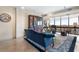 Sunlit living room showcasing floor-to-ceiling windows, a plush blue sofa, and elegant decor at 145 15Th Ne St # 843, Atlanta, GA 30309
