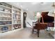 Cozy living room showcasing a grand piano, built-in shelving filled with decorative items and art at 145 15Th Ne St # 843, Atlanta, GA 30309
