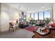 Comfortable living room with large windows, neutral carpet, and classic decor at 145 15Th Ne St # 843, Atlanta, GA 30309