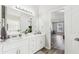 Bright bathroom featuring double sinks, white cabinets, a soaking tub, a separate shower, and access to the main bedroom at 1925 Meyers Dr, Lawrenceville, GA 30045