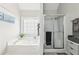 Bright bathroom with a soaking tub and a separate shower with sleek sliding doors at 1925 Meyers Dr, Lawrenceville, GA 30045