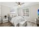 Comfortable bedroom with natural light, a queen-size bed, stylish decor, and hardwood floors at 1925 Meyers Dr, Lawrenceville, GA 30045