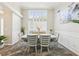 Elegant dining room with wainscoting, modern chandelier, large window, and seating for six at 1925 Meyers Dr, Lawrenceville, GA 30045