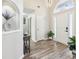 Open entryway with high ceilings, light hardwood floors, a decorative niche, and modern light fixtures at 1925 Meyers Dr, Lawrenceville, GA 30045