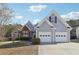 Charming home featuring a two-car garage, beautiful landscaping, and a mix of brick and siding exterior at 1925 Meyers Dr, Lawrenceville, GA 30045