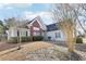 Exterior view of a light blue house, showing a brick feature and winter landscaping around the property at 1925 Meyers Dr, Lawrenceville, GA 30045
