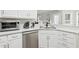 Bright kitchen features stainless steel appliances, quartz countertops, and white cabinetry at 1925 Meyers Dr, Lawrenceville, GA 30045