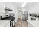 Bright kitchen features stainless steel appliances, gas range, quartz countertops, and white cabinetry at 1925 Meyers Dr, Lawrenceville, GA 30045