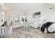 Spacious living room with an open layout, hardwood floors, comfortable seating, and a view of the dining area at 1925 Meyers Dr, Lawrenceville, GA 30045